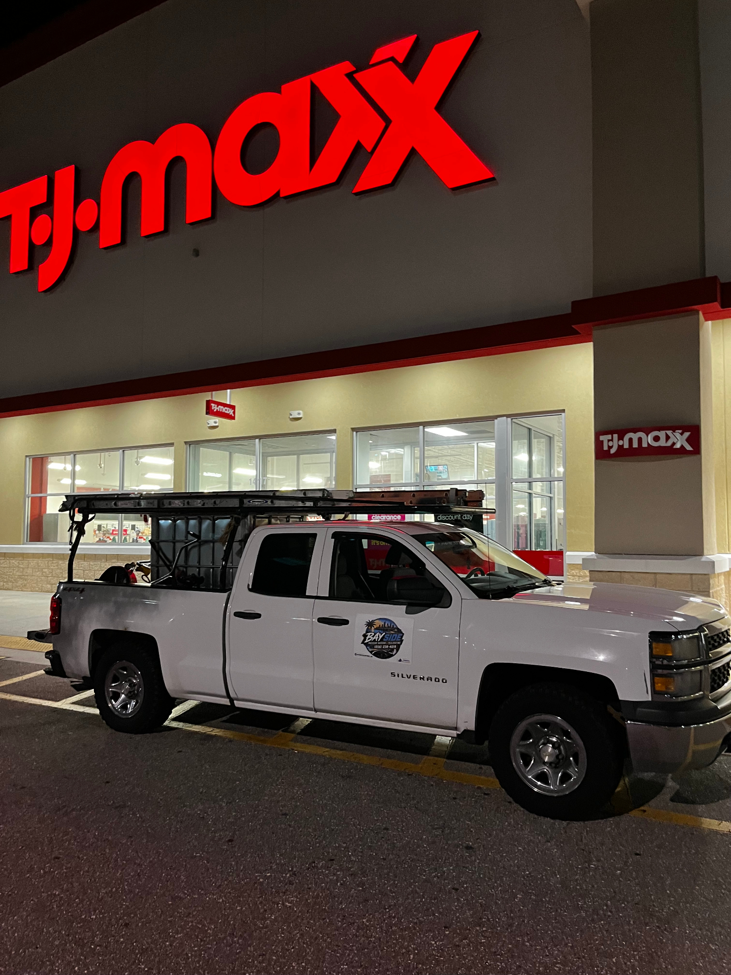Bayside Sealcoating service truck parked at a commercial job site at night